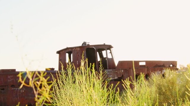 Moynaq Ship Graveyard Uzbekistan sunrise. Rusted fishing vessels stranded in the Aralkum Desert. Environmental disaster memorial showing the dried Aral Sea and lost maritime heritage in Muynak.