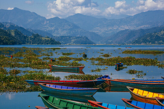 Fhewa lake with boats and mountains around,  landscape in Pokhara Nepal