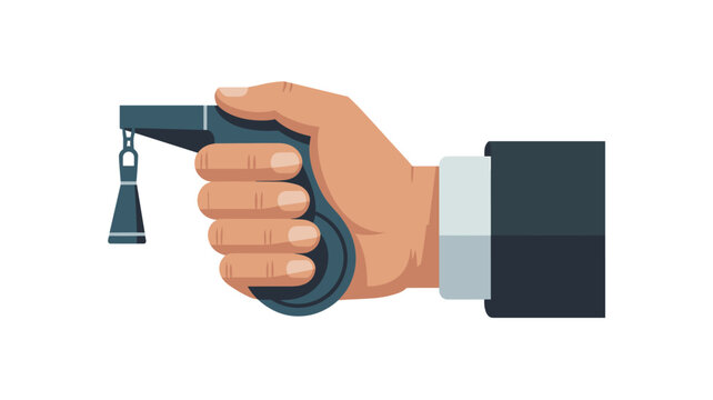 A professional hand wearing a dark suit cuff holds a small handheld clicker or signaling device with a hanging tassel accessory against a clean white surface.