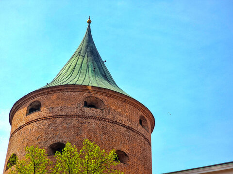 Powder Tower Riga &mdash; Medieval Brick Fortification with Conical Green Copper Roof and Defensive Embrasures Old European City 
