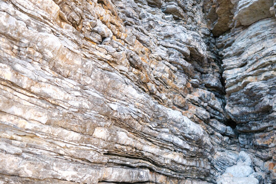 Explore the stunning limestone rock formations by the Adriatic Sea, showcasing beautiful parallel layering and natural textures