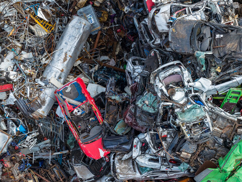 Aerial view of scrapped cars and crushed metal debris piled in a junkyard and recycling site in Hoogeveen, Drenthe, Netherlands.