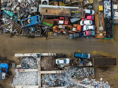 Aerial view of scrapped cars and crushed metal debris piled in a junkyard and recycling site in Hoogeveen, Drenthe, Netherlands.