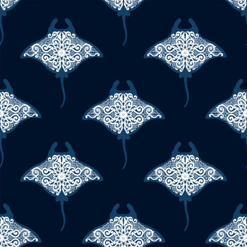 Seamless pattern with white ornamental manta rays on dark blue background