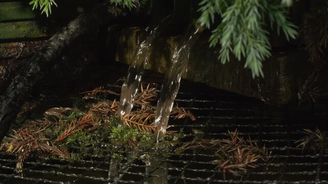 Water flowing into a garden pond from a filter stock footage