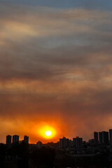 Fototapeta premium A thick layer of smoke covered the brazilian city during the late afternoon. The hot, dry weather and the air heavy with smoke make it harder for people to breathe.