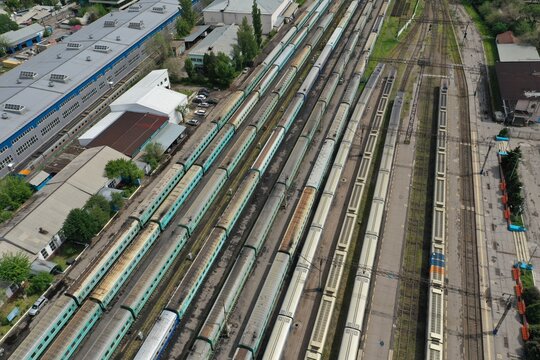 Aerial View of Multiple Passenger Trains Stationed on Parallel Railway Tracks