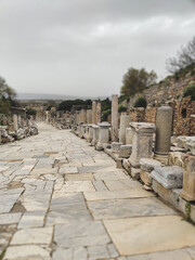Fototapeta premium Curetes Street with ancient marble columns and ruins in archaeological site of Ephesus Turkey