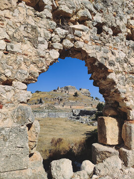 Ancient Lycian acropolis seen through a stone arch in Tlos Turkey