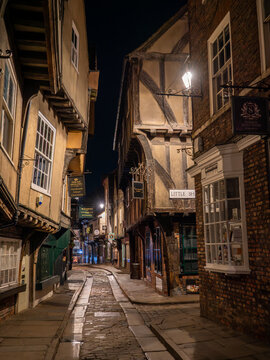 York, Yorkshire, United Kingdom - 23 February 2026 : The Shambles in York at night showing the lamplit medieval houses lining the street.