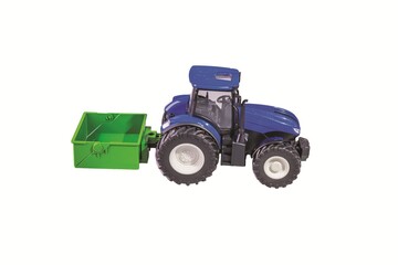 Obraz premium Close-up view of blue remote control toy tractor with trailer isolated on white background. Sweden.