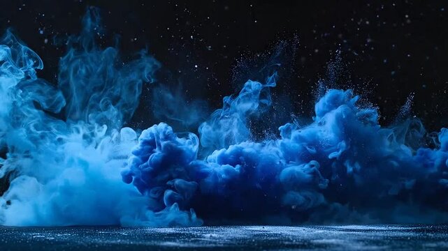 Vibrant blue powder particles explode against a deep black background