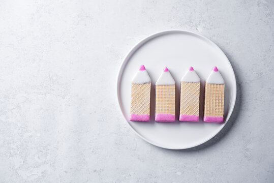 Chocolate wafers in the shape of pencils in a plate