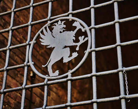 Detail of a metal grate featuring a griffin silhouette within a circle, Perugia, Italy, Europe