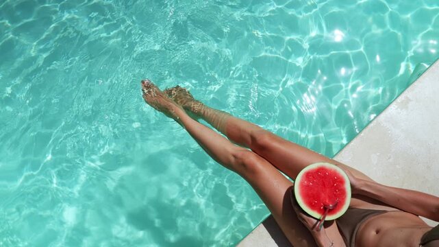 Woman with watermelon refreshing in the pool