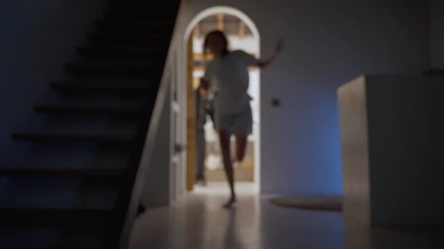 Frightened woman escaping from a killer with a knife