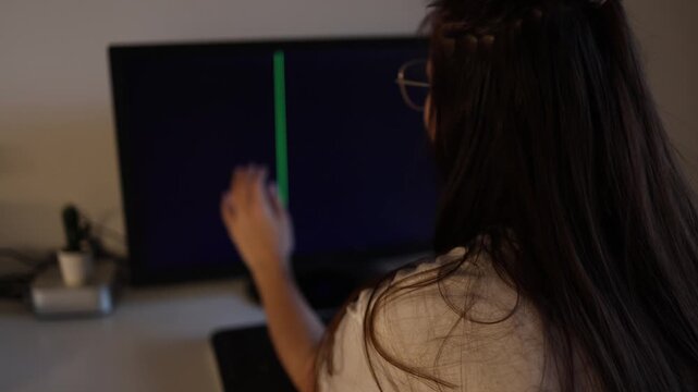 Young woman sitting at computer with broken monitor black screen and glitch lines frustrated remote work atmosphere technology problem cinematic indoor scene