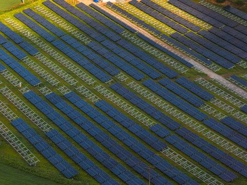 Aerial view of the FVE Bohumilice solar farm with rows of photovoltaic panels installed on a green field in Klobouky u Brna, Jihomoravsky kraj, Czechia.