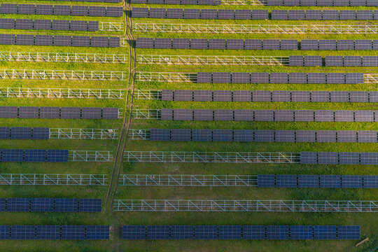 Aerial view of FVE Bohumilice solar power plant with rows of photovoltaic panels on a green field in Klobouky u Brna, Jihomoravsky kraj, Czechia.