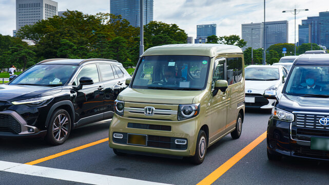 Tokyo, Japan - Oct 1 2024, a panoramic view of a Honda N-VAN kei ​​car parked in a parking lot surrounded by other cars, at daytime, Tokyo, Japan