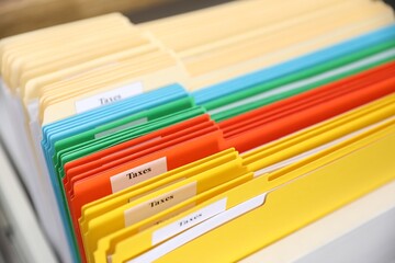 Fototapeta premium Tax. Many folders in drawer of cabinet in office, closeup