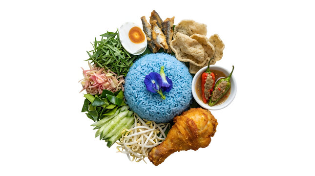 Traditional Malaysian blue rice Nasi Kerabu with assorted herbs and side dishes, isolated on white