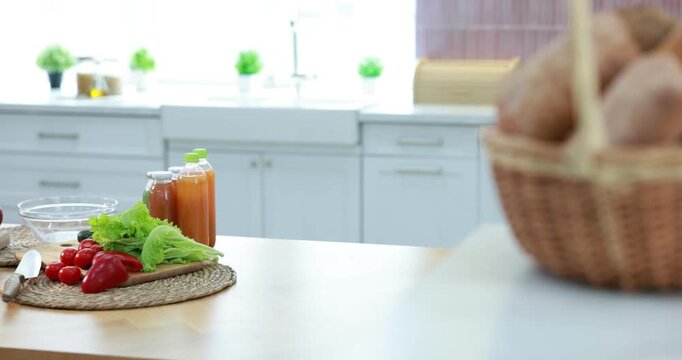 Fresh vegetables, fruits, drinks and bread in kitchen, camera moving right