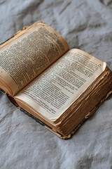Fototapeta premium Antique Open Book with Faded Typography: Dive into History and Literature
