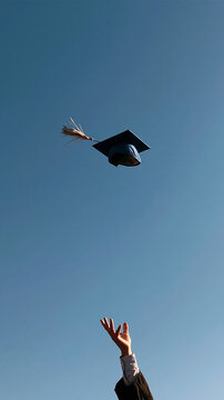 Graduation Cap Toss Celebration: Capturing Academic Achievement and New Beginnings on a Sunny Day