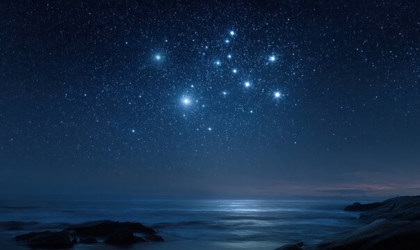 Starry night over sea, Ursa Minor visible, calm waters, rocky shoreline