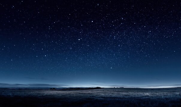 Night sky filled with stars over quiet, empty plains