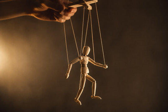 AI generated wooden puppet controlled by human hand with dramatic lighting symbolizing manipulation power influence and psychological control themes