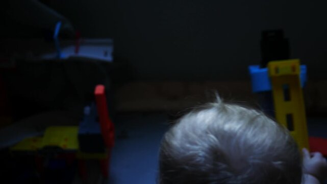 A Baby Plays with a Toy Playset