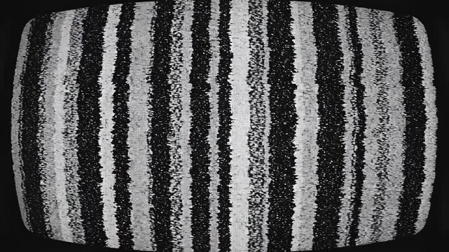 Vintage television screen displays static and test pattern in monochrome