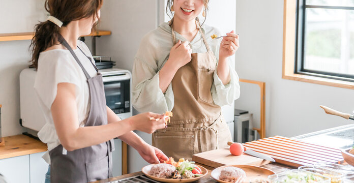 A female instructor and a female student teaching cooking at a cooking class/cooking school.