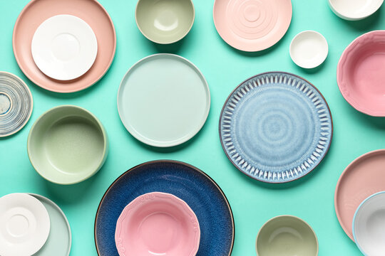 Different plates with bowls on turquoise background
