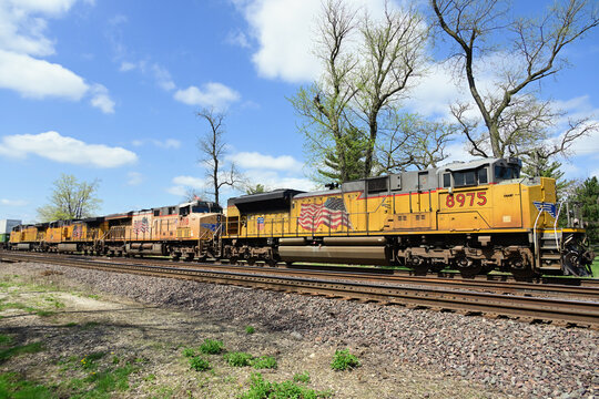 Four Union Pacific Railroad locomotives lead an eastbound stack train through a suburban Chicago community destined for UP's nearby Gloval 2 facility..