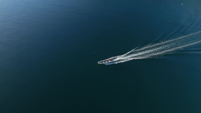 Motor boat moves fast in the open sea. Aerial view of the speed boat