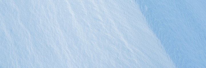 Obraz premium Snow texture. Wind sculpted patterns on snow surface. Wind in the tundra and in the mountains on the surface of the snow sculpts patterns and ridges. Arctic, Polar region. Winter panoramic background.