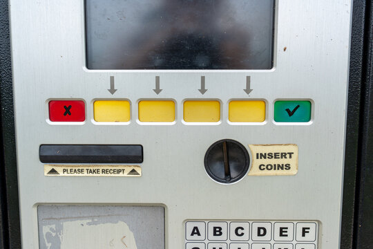 Close-up of a parking meter with coin slot and card reader, representing modern urban payment options and hybrid cashless solutions