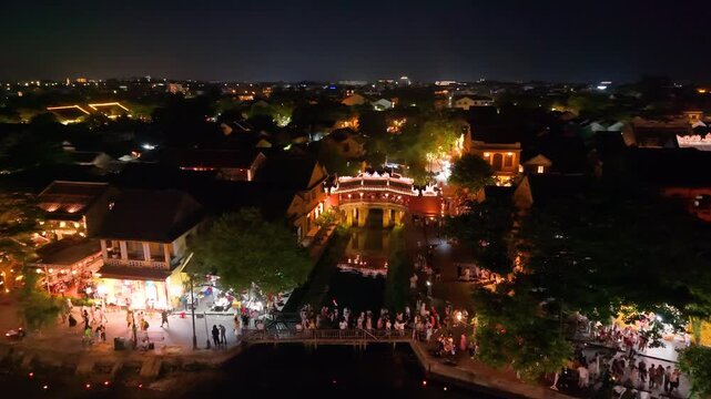 Aerial view of Chua Cau or Japanese Covered ancient Bridge and River in Hoi An old town at evening night, One of the most travel popular touristic destinations in VietNam, UNESCO world heritage 