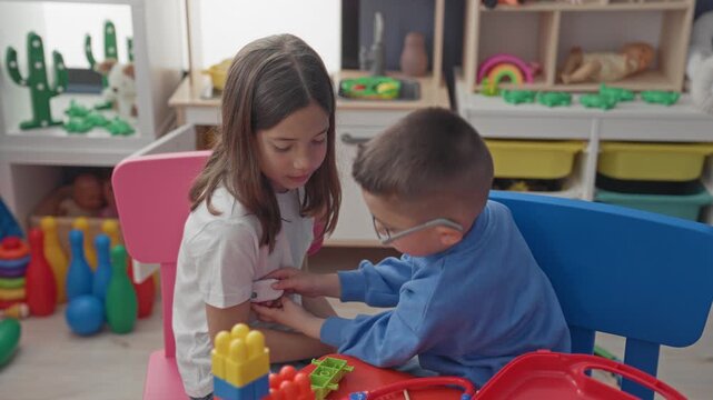 Girl and boy play doctor with toy stethoscope and place a bandage on her arm in a building; compassion imaginative play.