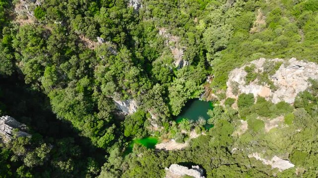 Top Down Aerial View of Polylimnio Waterfall Pools and Rocky Forest Canyon in Peloponnese Greece