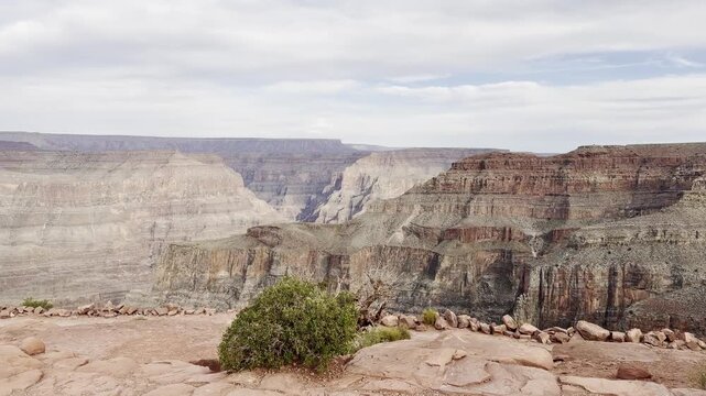 Scenic panoramic view of the Grand Canyon West Rim in Arizona, USA. Desert landscape with layered red rock cliffs, deep canyon formations, Colorado River view. A road trip near Eagle and Guano Point.