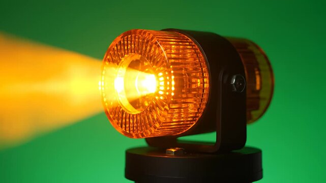 Orange warning light emitting bright beam ideal for creative backgrounds and modern web design