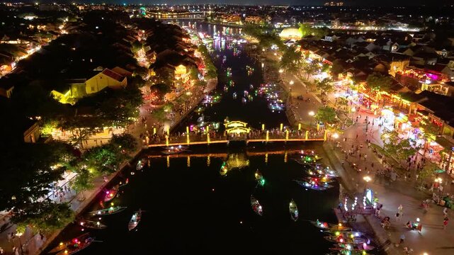 Timelapse or time-lapse of panorama aerial view of Hoi an ancient town in evening. Royalty high-quality stock of Hoai river and boat tour night traffic. One of the most popular touristic destination