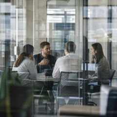 Fototapeta premium Focused professionals in business meeting discussing joyfully