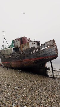 The Corpach Shipwreck on Rocky Beach Near Fort William, Scotland, Maritime Heritage Travel Landmark, Vertical