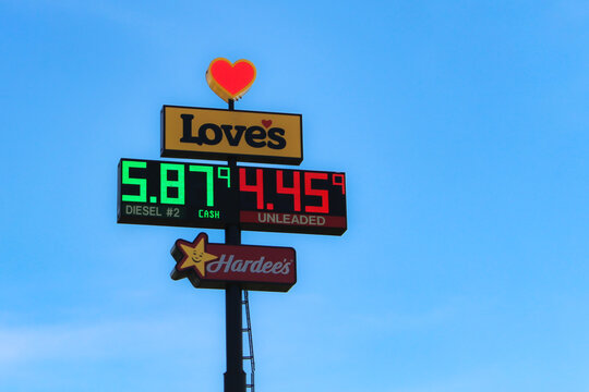 Love's travel stop sign with fuel prices for diesel and gasoline with clear blue sky. Hardee's restaurant sign below (Wisconsin, USA - May, 14, 2026). Editorial Use Only.