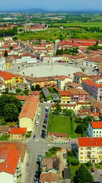 Vertical video. Palmanova, Udine, Italy. The nine-pointed star fortress city, Drone footage over terracotta rooftops and the hexagonal Piazza Grande at the geometric heart of this Renaissance militar